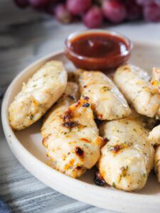 Air Fry Chicken Tenders on a plate with ketchup.