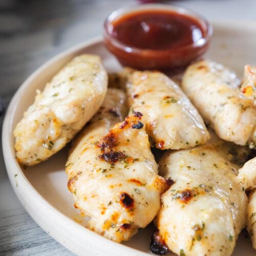 Air Fry Chicken Tenders on a plate with ketchup.