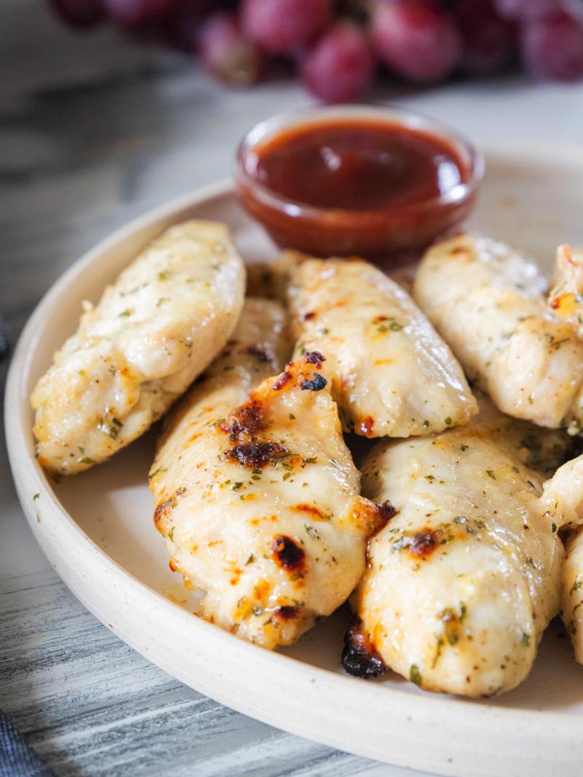 Air Fry Chicken Tenders on a plate with ketchup.