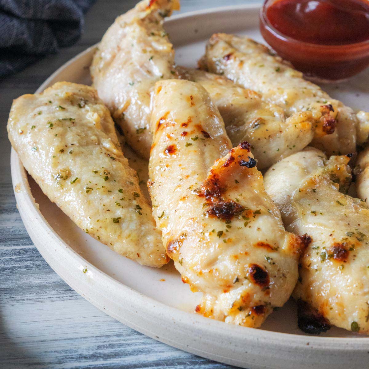 Air Fry Chicken Tenders on a plate with ketchup.